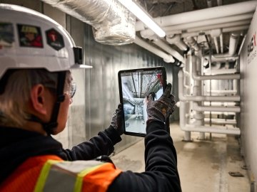 A person holding a tablet.