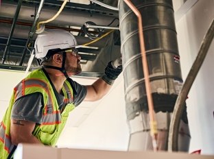 Person inspecting construction work.