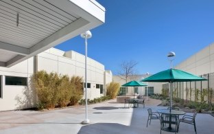 Outdoor image of table, chairs and two umbrellas