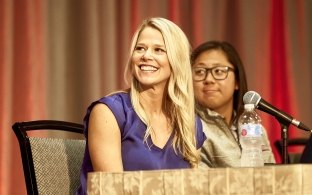 Employee at a table smiling