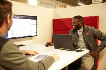 A person smiling and working at his computer.