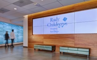 Large video screen on lobby wall in Rady Children’s Hospital Administrative Building and Conference Center 