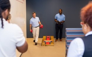 Employees playing cornhole