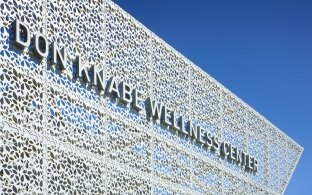 Close up of the building sign outdoors with a blue sky