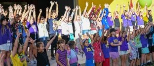 children raising their hands