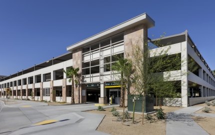 Outdoor entrance to the parking garage with palm trees out front