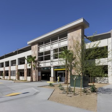 Outdoor entrance to the parking garage with palm trees out front