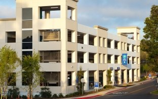 road, trees, parking structure building exterior