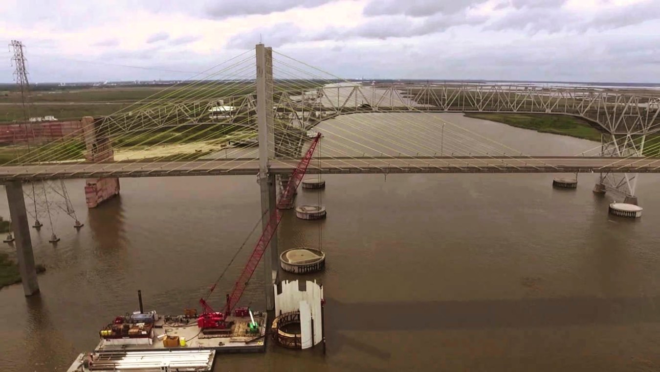 A crane on a barge in the water during construction