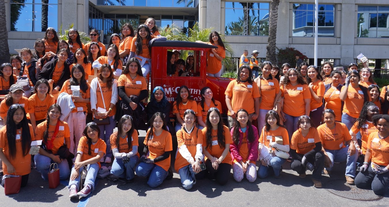 Group of students in front of and around the vintage McCarthy truck.