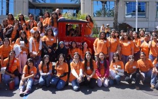 Group of students in front of and around the vintage McCarthy truck.