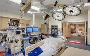 Surgical room with monitors, lights and an operating bed