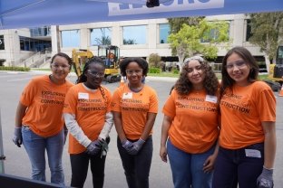 Group of people posing at McCarthy's Exploring STEM Through Construction Event. 