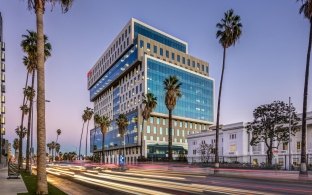 Sunset Bronson Studios ICON Office Tower with surrounding buildings, roadway and palm trees