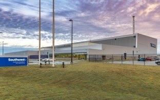 Exterior view of the hangar with grass in the foreground of the photo