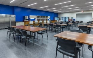 A classroom style room with tables and chairs