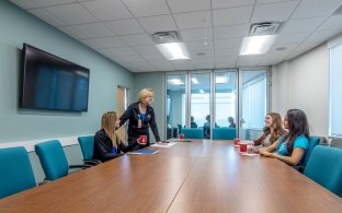 People sitting at a table in a conference room