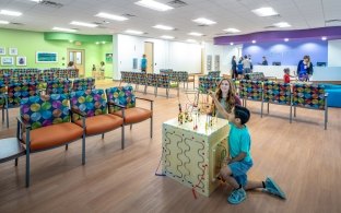 Children playing with a toy in a waiting room