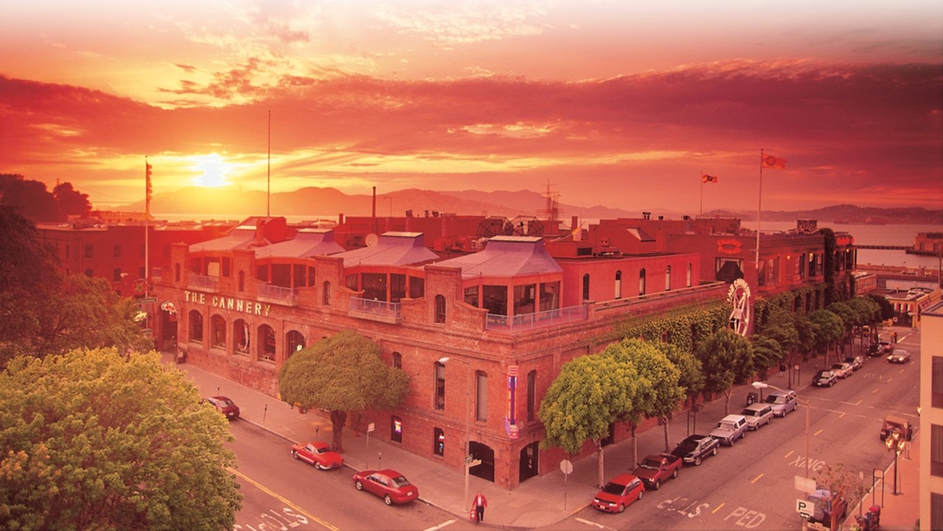 Aerial exterior view of The Cannery with a sunset in the background.