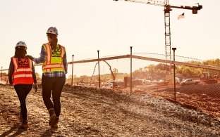 Construction workers walking around a jobsite.