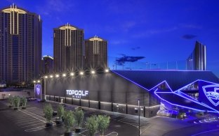 Exterior view of the Topgolf building at nighttime