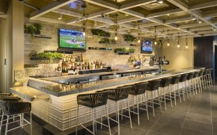 A bar area with high top chairs