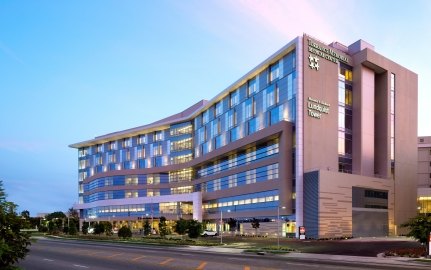 Outdoor image of the medical center with blue windows and a blue sky