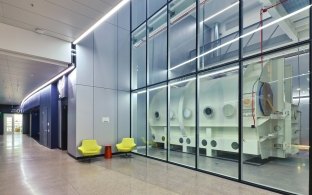 Indoor image of a hallway with glass windows