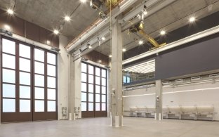 Indoor room with elevated ceiling and garage doors