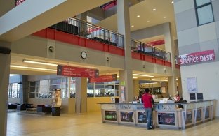 A person standing at a check in desk at the recreation center