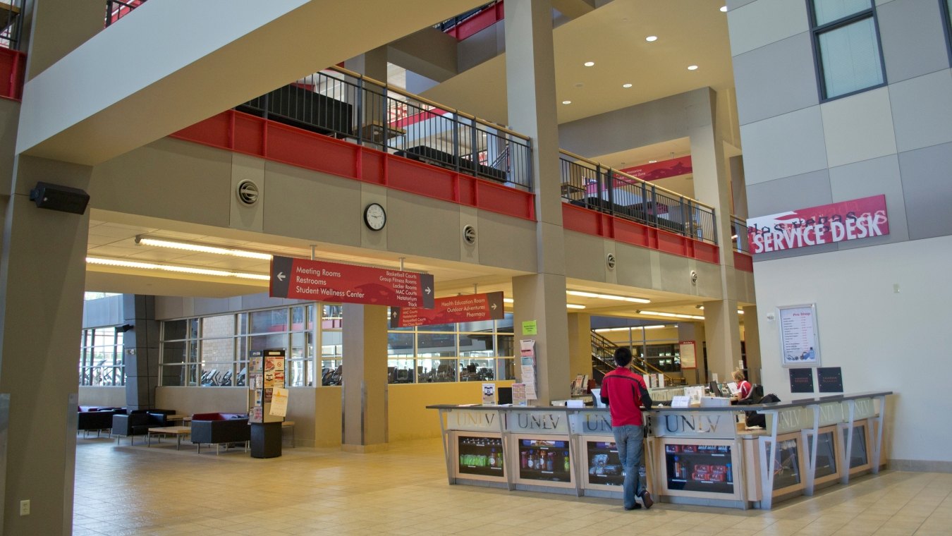 A person standing at a check in desk at the recreation center