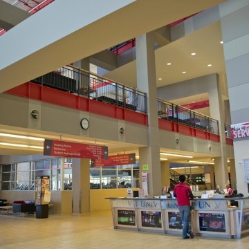 A person standing at a check in desk at the recreation center