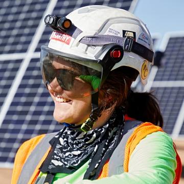 Employee in front of solar field