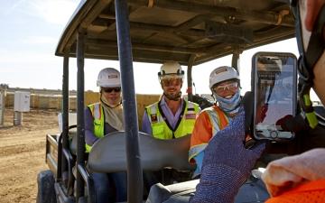 Taking photo of employees in golf cart on solar job