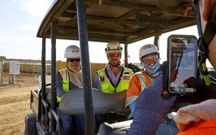 Taking photo of employees in golf cart on solar job