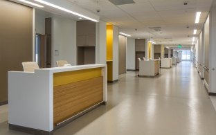 A hospital hallway with nurses' stations.