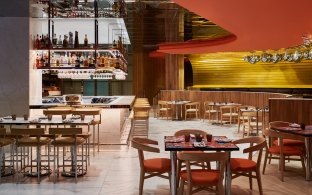 Bar and seating area with tables, chairs, and high-top chairs