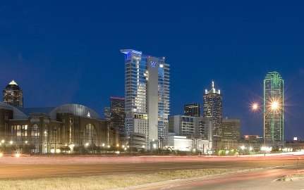 Exterior view of the hotel from the roadway at nighttime