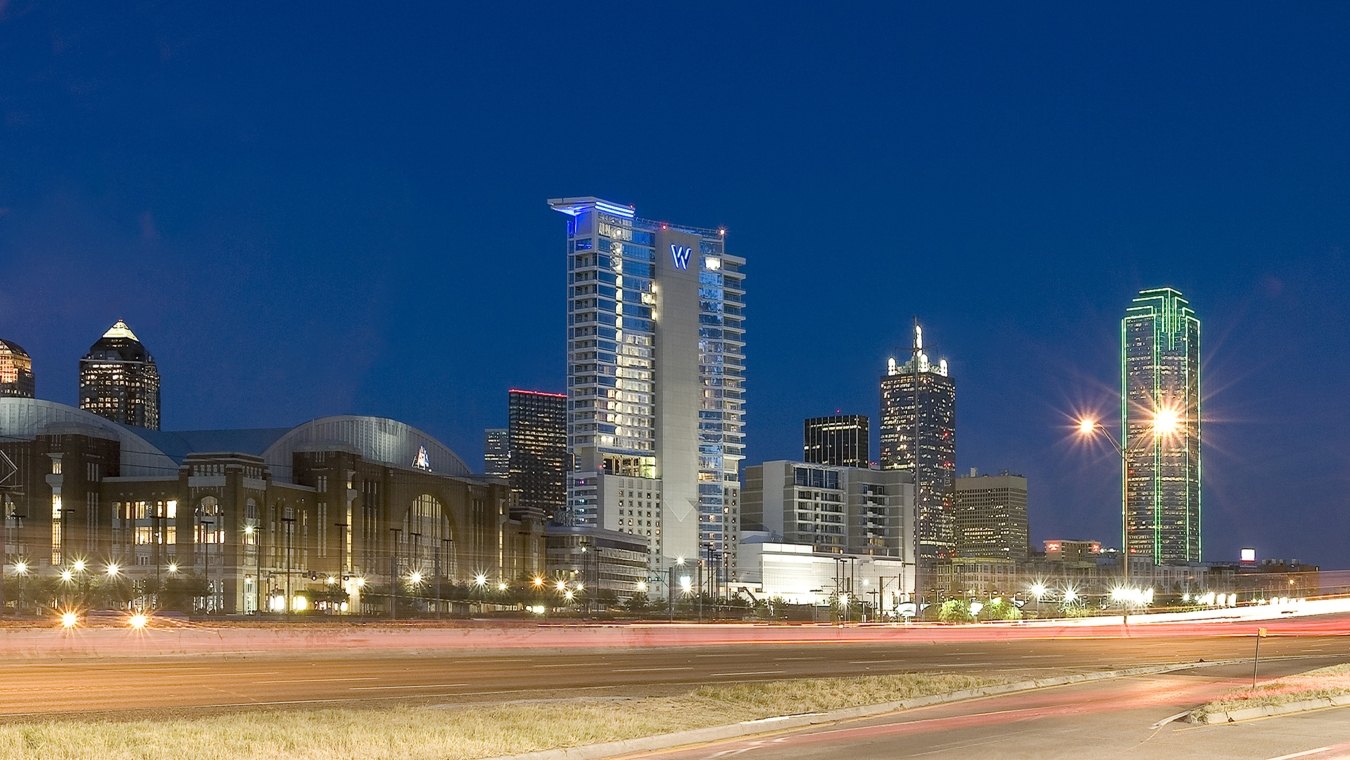 Exterior view of the hotel from the roadway at nighttime