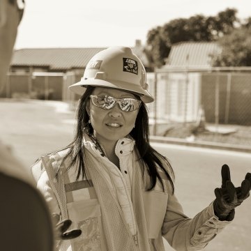 Construction having a conversation with another person on a jobsite.