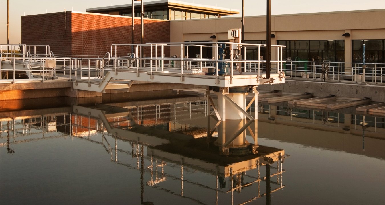 Water and pipes in front of the water treatment plant building