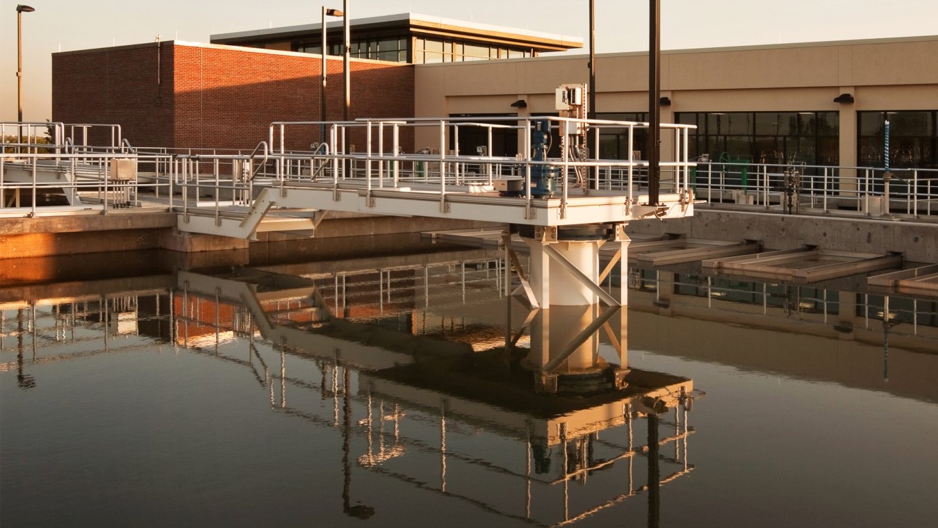 Water and pipes in front of the water treatment plant building