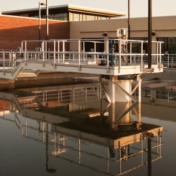 Water and pipes in front of the water treatment plant building