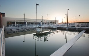 Water and pipes in front of the water treatment plant building